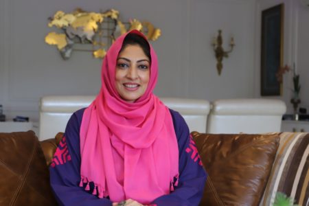 portrait of a woman wearing a pink hijab 